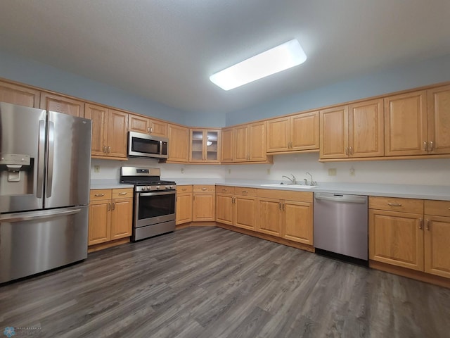 2501 30th Ave S Unit 109, Fargo, ND 58103 - kitchen with stainless steel appliances, dark wood-type flooring, light countertops, and glass insert cabinets