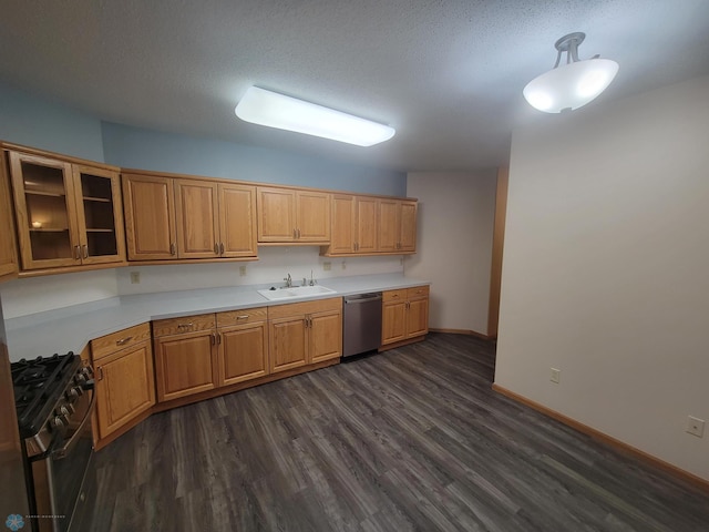 2501 30th Ave S Unit 109, Fargo, ND 58103 - kitchen featuring black gas range oven, dishwasher, dark wood-style flooring, light countertops, and glass insert cabinets
