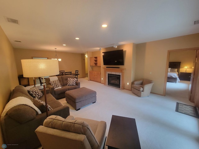 2501 30th Ave S Unit 109, Fargo, ND 58103 - living room with light carpet, a tiled fireplace, and recessed lighting