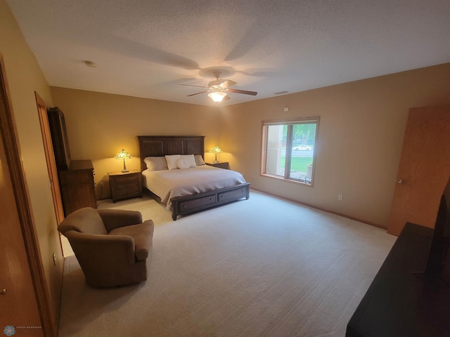 2501 30th Ave S Unit 109, Fargo, ND 58103 - bedroom featuring light colored carpet, a ceiling fan, and a textured ceiling