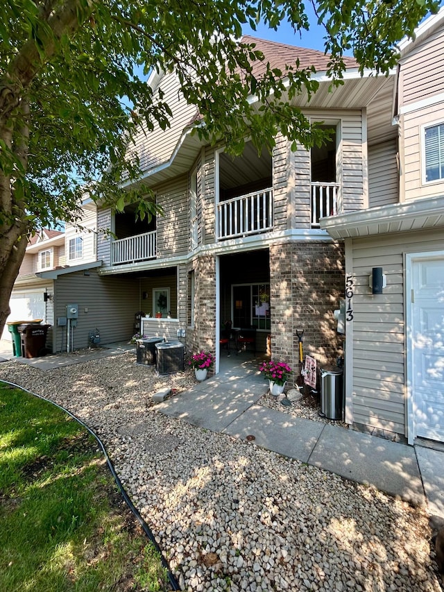 5613 100th Ln N, Brooklyn Park, MN 55443 - rear view of property featuring a balcony and a patio