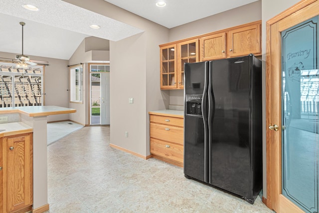 42 Pullman Ave, Saint Paul Park, MN 55071 - kitchen featuring black refrigerator with ice dispenser, glass insert cabinets, light countertops, a ceiling fan, and lofted ceiling