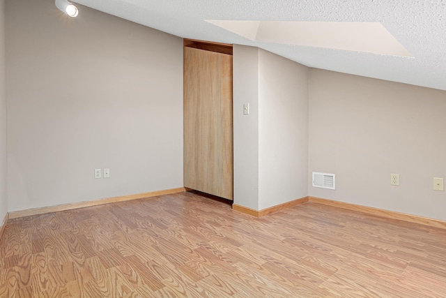 42 Pullman Ave, Saint Paul Park, MN 55071 - empty room featuring light wood finished floors and a textured ceiling