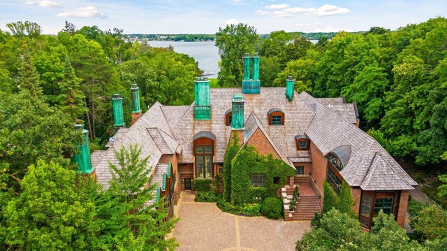 17950 Breezy Point Rd, Woodland, MN 55391 - view of front of property featuring a chimney, a water view, stairway, and french doors