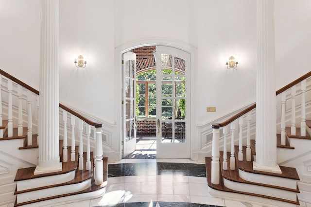 17950 Breezy Point Rd, Woodland, MN 55391 - foyer entrance featuring stairway, a towering ceiling, and arched walkways