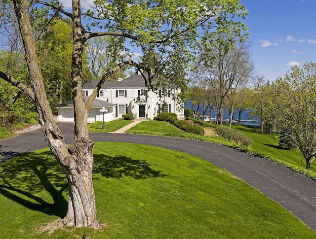 17950 Breezy Point Rd, Woodland, MN 55391 - view of front of property featuring a front lawn, driveway, and a garage