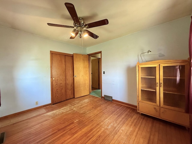 12900 350th Ave SE, Deer Park Twp, MN 56684 - unfurnished bedroom with light wood-style floors, a ceiling fan, and a closet