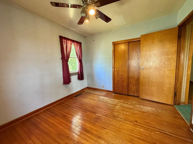 12900 350th Ave SE, Deer Park Twp, MN 56684 - unfurnished bedroom featuring wood-type flooring, a closet, and ceiling fan