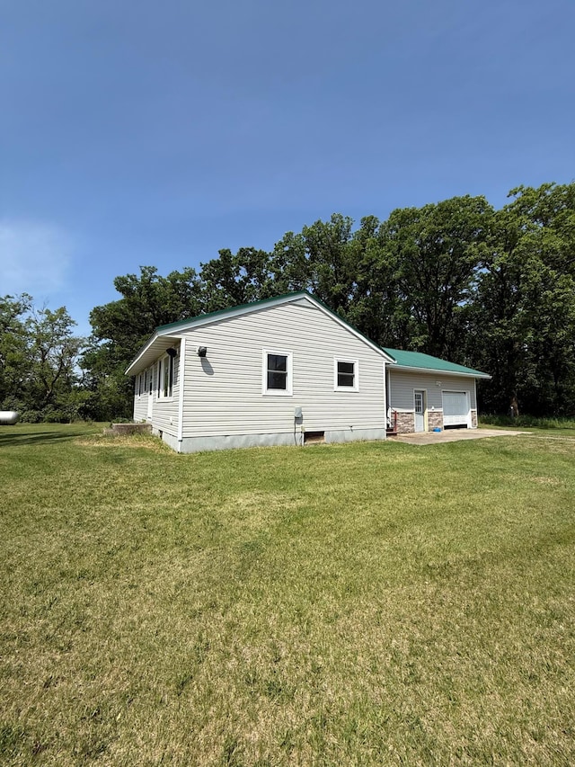 12900 350th Ave SE, Deer Park Twp, MN 56684 - view of property exterior featuring a yard and a garage