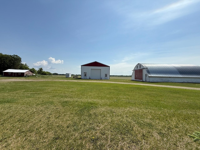 12900 350th Ave SE, Deer Park Twp, MN 56684 - view of grassy yard with a detached garage and an outbuilding