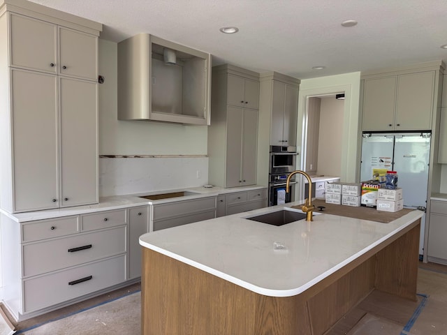 5260 Polaris Ln, Plymouth, MN 55446 - kitchen with gray cabinets, double oven, light countertops, and a center island with sink