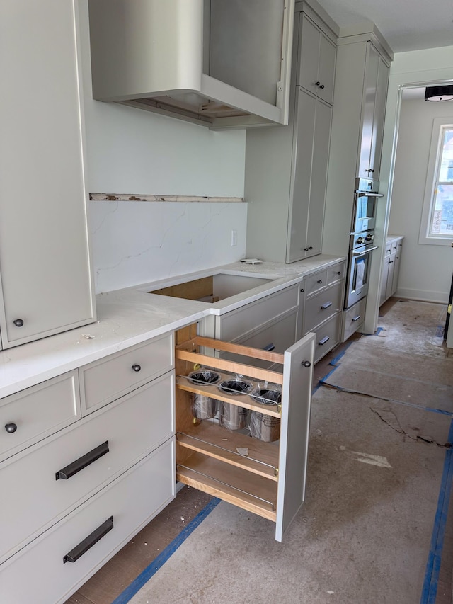 5260 Polaris Ln, Plymouth, MN 55446 - kitchen featuring gray cabinetry, double oven, and exhaust hood