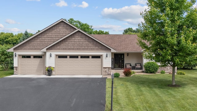 1364 Island View Dr, New Richmond, WI 54017 - view of front facade featuring a garage, asphalt driveway, a front yard, and stone siding