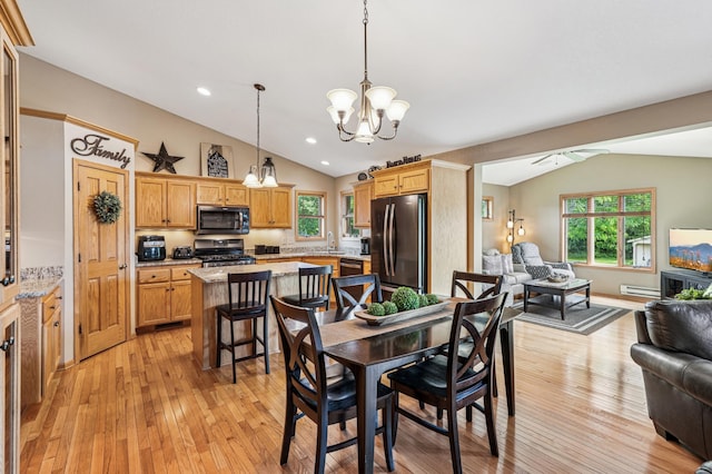 1364 Island View Dr, New Richmond, WI 54017 - dining area with vaulted ceiling, a chandelier, a baseboard radiator, light wood-style floors, and healthy amount of natural light
