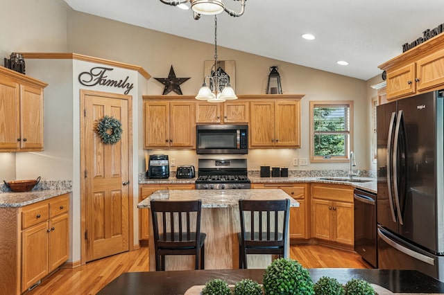 1364 Island View Dr, New Richmond, WI 54017 - kitchen featuring stainless steel appliances, lofted ceiling, a chandelier, light wood-style floors, and light stone countertops