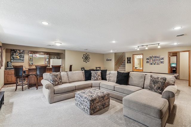 1364 Island View Dr, New Richmond, WI 54017 - living room featuring light colored carpet, bar area, a textured ceiling, stairs, and recessed lighting