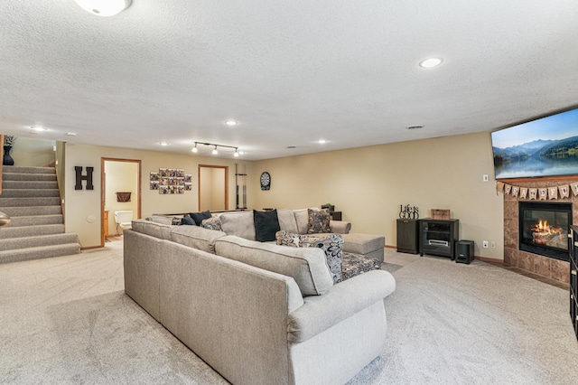 1364 Island View Dr, New Richmond, WI 54017 - living room featuring carpet flooring, stairs, recessed lighting, a textured ceiling, and a tile fireplace