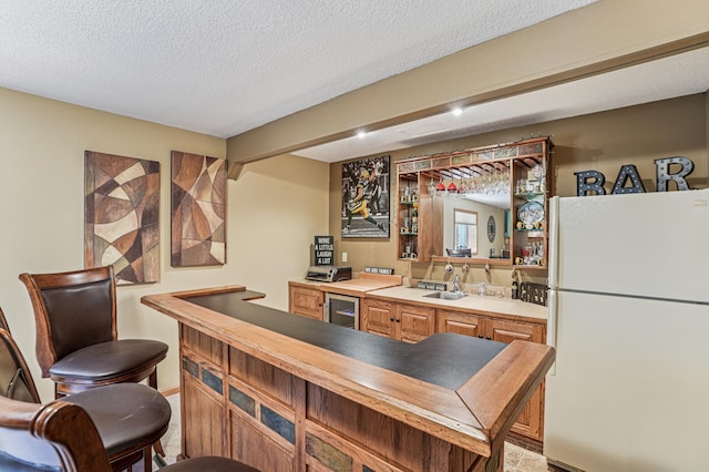 1364 Island View Dr, New Richmond, WI 54017 - indoor wet bar featuring freestanding refrigerator, a textured ceiling, and beverage cooler