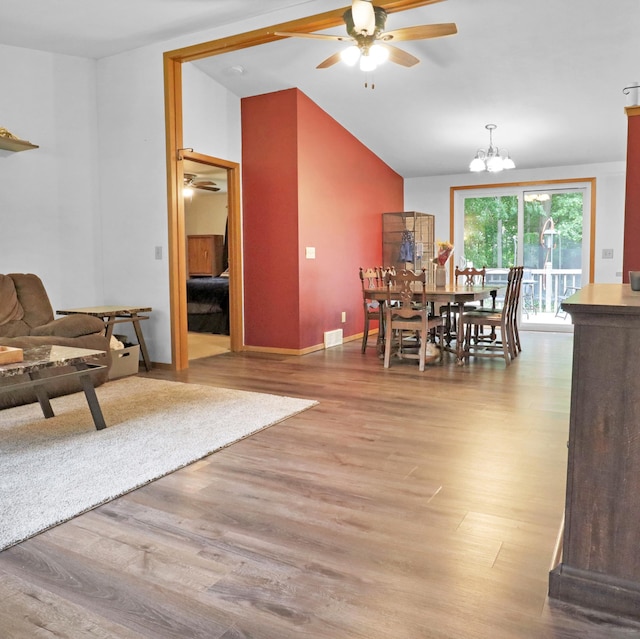 112 3rd St, Luck, WI 54853 - dining area featuring a ceiling fan, vaulted ceiling, wood finished floors, and a chandelier