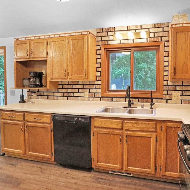 112 3rd St, Luck, WI 54853 - kitchen with black dishwasher, gas range, decorative backsplash, light countertops, and light wood finished floors