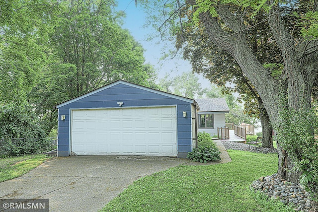 50875 Almond Ave, Nessel Twp, MN 55080 - view of front facade with a front yard, a detached garage, and roof with shingles