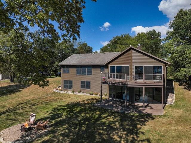 7 3rd St, Pepin, WI 54759 - rear view of property with an outdoor fire pit, a patio, a lawn, a wooden deck, and a chimney