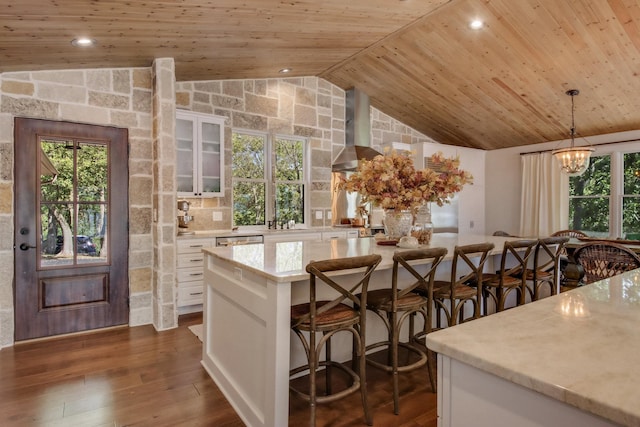 7 3rd St, Pepin, WI 54759 - kitchen featuring wall chimney range hood, wood ceiling, vaulted ceiling, white cabinets, and plenty of natural light