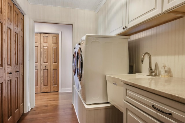 7 3rd St, Pepin, WI 54759 - laundry room featuring cabinet space, independent washer and dryer, and wood finished floors