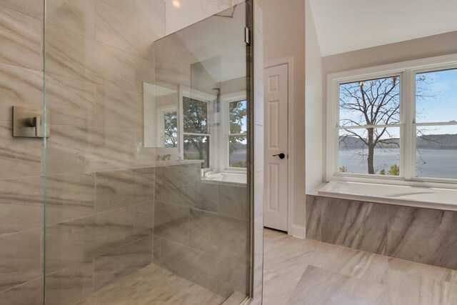 7 3rd St, Pepin, WI 54759 - bathroom with a tile shower, healthy amount of natural light, and vaulted ceiling