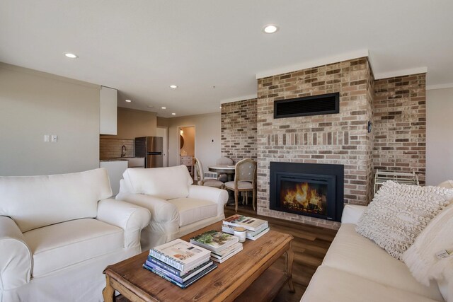 7 3rd St, Pepin, WI 54759 - living area with recessed lighting, a fireplace, dark wood-style floors, and crown molding