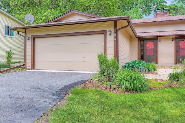 2833 Flag Ave N, New Hope, MN 55427 - view of front facade with driveway, an attached garage, and a chimney