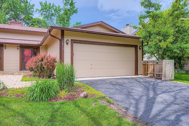 2833 Flag Ave N, New Hope, MN 55427 - view of front facade featuring a chimney, driveway, and an attached garage