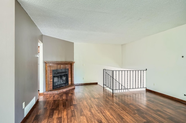 2833 Flag Ave N, New Hope, MN 55427 - unfurnished living room featuring wood finished floors, a textured ceiling, and a fireplace
