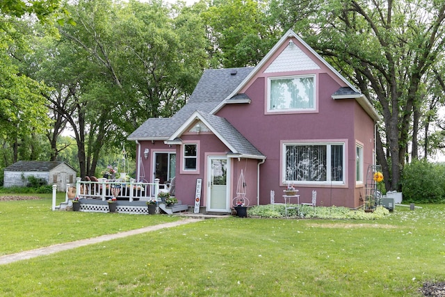 37245 US Highway 59 SE, Knute Twp, MN 56556 - victorian home featuring stucco siding, a wooden deck, a front yard, and roof with shingles