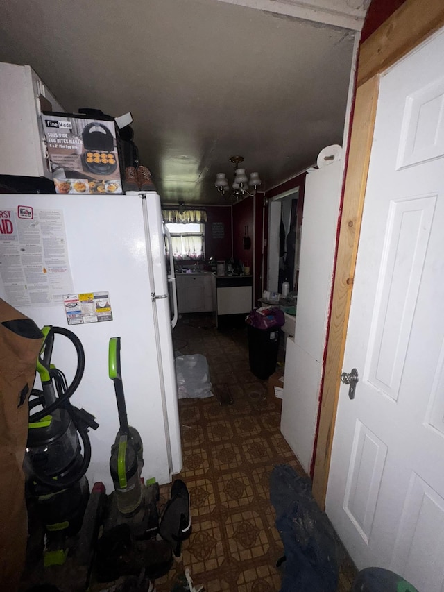 201 Harrison Ave, Sacred Heart, MN 56285 - kitchen with freestanding refrigerator, a chandelier, and dark floors