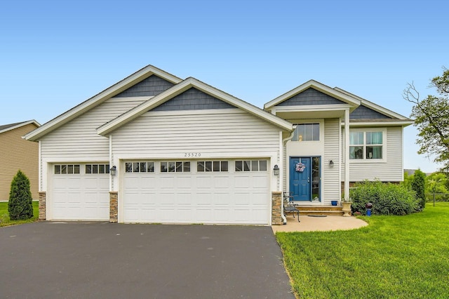 25520 10th St W, Zimmerman, MN 55398 - view of front facade with driveway, stone siding, a front lawn, and a garage