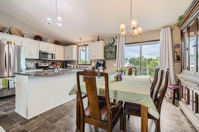 25520 10th St W, Zimmerman, MN 55398 - dining area featuring a chandelier, stone tile floors, and vaulted ceiling