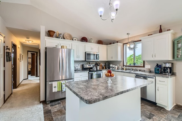 25520 10th St W, Zimmerman, MN 55398 - kitchen featuring stainless steel appliances, lofted ceiling, a kitchen island, white cabinets, and decorative light fixtures