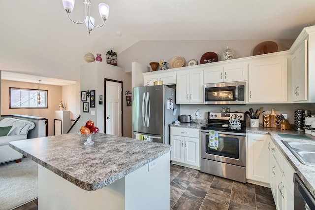 25520 10th St W, Zimmerman, MN 55398 - kitchen featuring stainless steel appliances, vaulted ceiling, a chandelier, white cabinetry, and pendant lighting