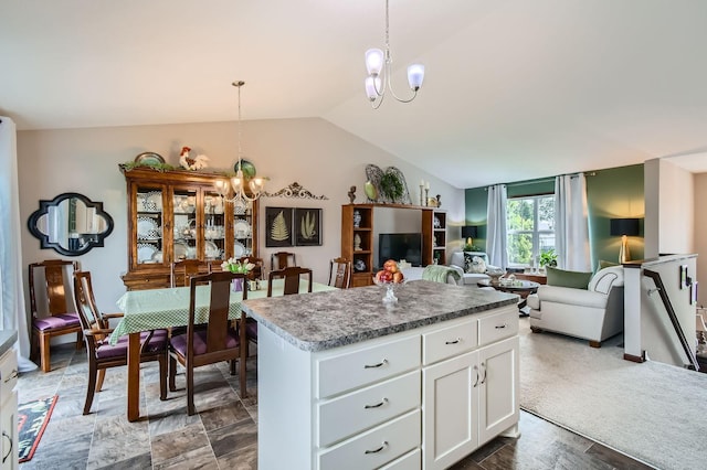 25520 10th St W, Zimmerman, MN 55398 - kitchen featuring a chandelier, vaulted ceiling, a kitchen island, white cabinets, and decorative light fixtures