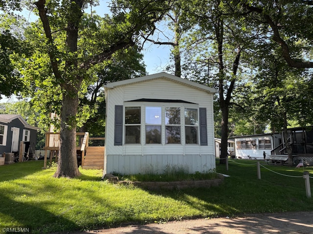 13496 Campfire Cir, South Haven, MN 55382 - view of side of home featuring a deck, a yard, and stairway