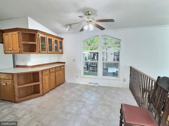 13496 Campfire Cir, South Haven, MN 55382 - kitchen with open shelves, brown cabinetry, ceiling fan, a textured ceiling, and light countertops
