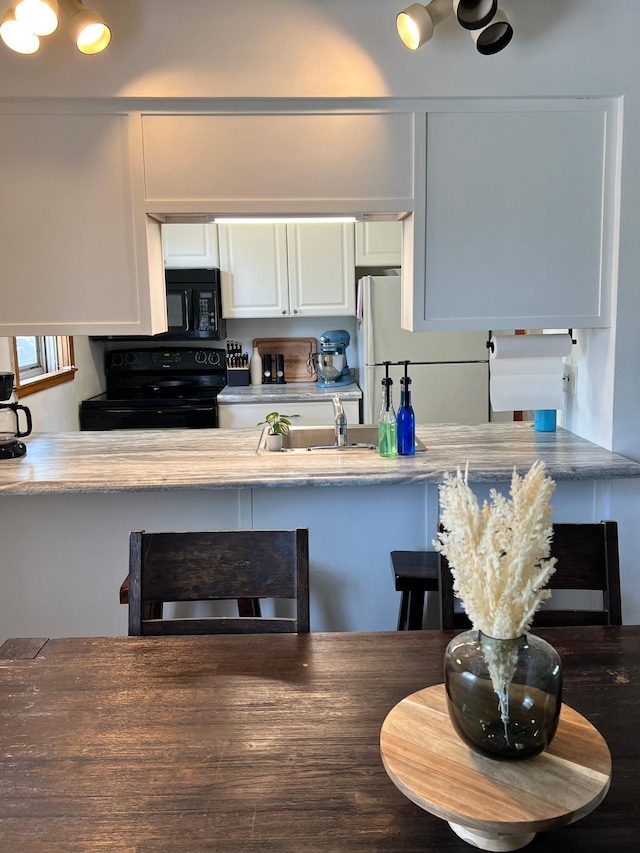 907 22nd Ave S, Moorhead, MN 56560 - kitchen with black appliances and white cabinets