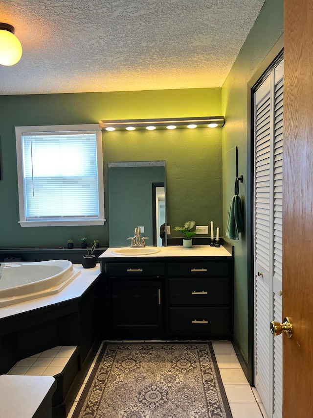 907 22nd Ave S, Moorhead, MN 56560 - bathroom with a closet, vanity, a textured ceiling, and a garden tub