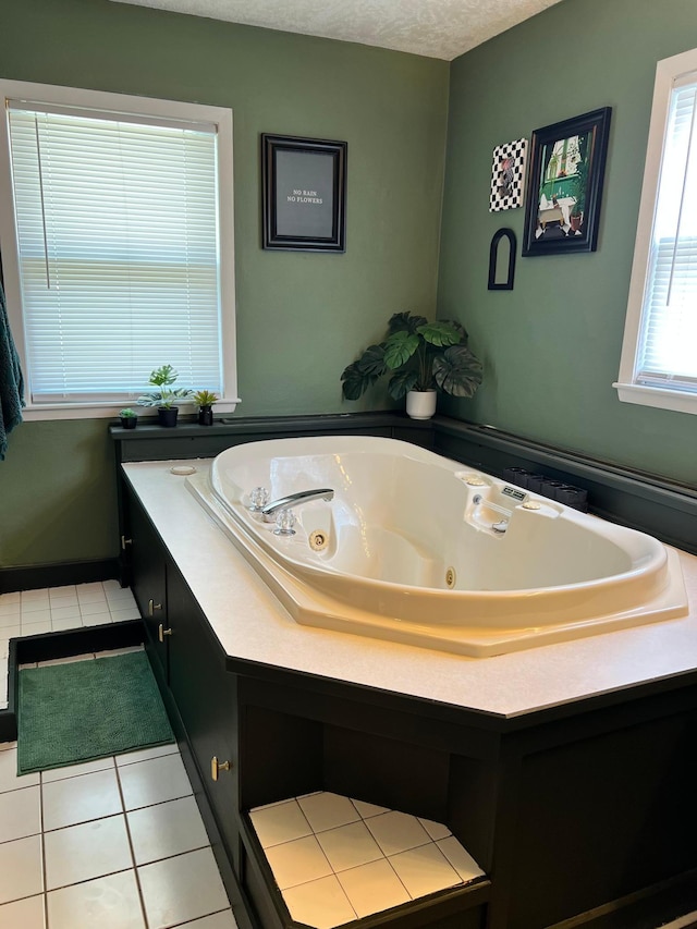 907 22nd Ave S, Moorhead, MN 56560 - bathroom with tile patterned flooring and a tub with jets