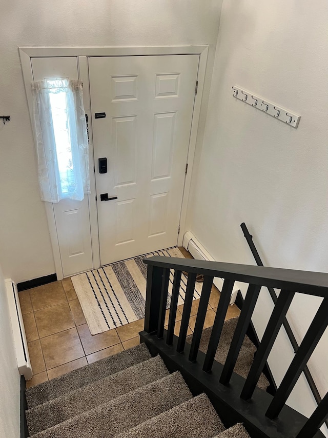 907 22nd Ave S, Moorhead, MN 56560 - tiled entryway with a baseboard heating unit and stairs