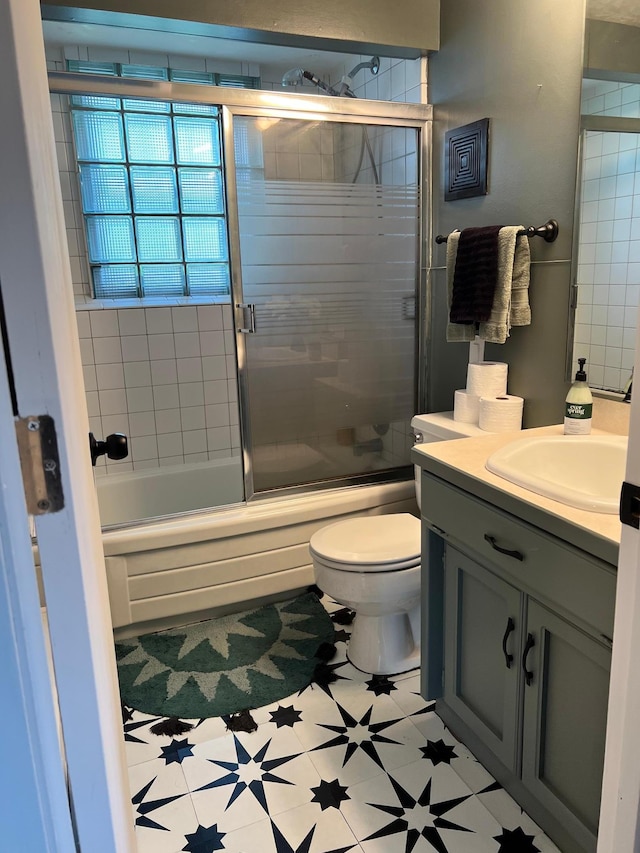 907 22nd Ave S, Moorhead, MN 56560 - bathroom with vanity and combined bath / shower with glass door