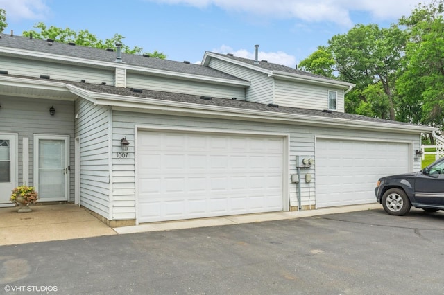 1007 124th Cir NW, Coon Rapids, MN 55448 - view of side of property featuring asphalt driveway