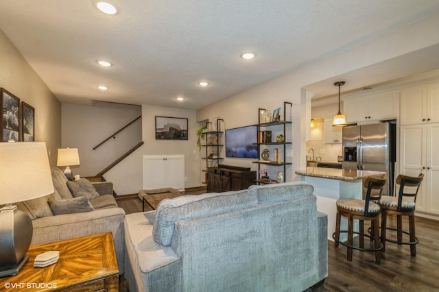 1007 124th Cir NW, Coon Rapids, MN 55448 - living room featuring recessed lighting, dark wood-style floors, and a textured ceiling