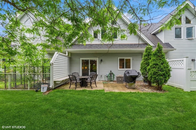 1007 124th Cir NW, Coon Rapids, MN 55448 - rear view of house with a shingled roof and a patio